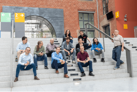 About a dozen members of entimo's team gathered on the steps of the interior courtyard at entimo's world headquarters.